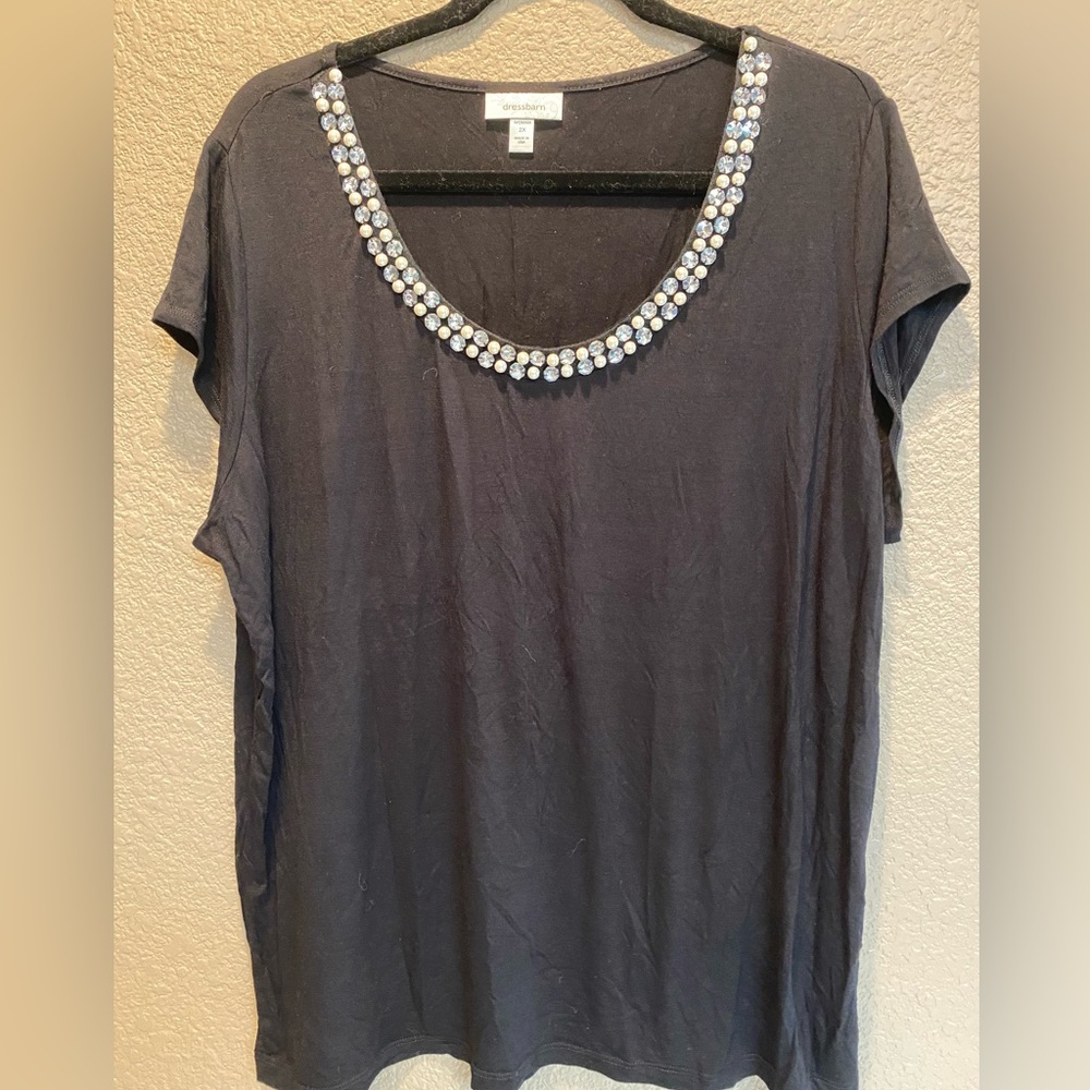 Women’s black cap sleeve top with diamond and pearl embellishments on neckline.